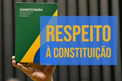 A foto mostra uma mão masculina segurando a Constituição Federal. À frente, sobre um fundo azul em transparência, a inscrição: Respeito à Constituição