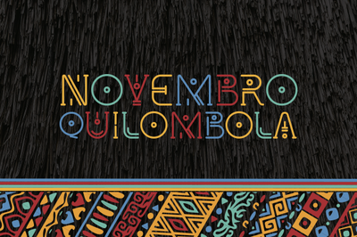 Arte retangular, com fundo escuro, barra horizontal em estilo afro, e a expressão Novembro Quilombola escrita em letras coloridas.