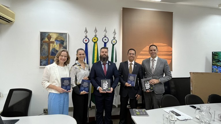 Foto de cinco pessoas segurando agendas