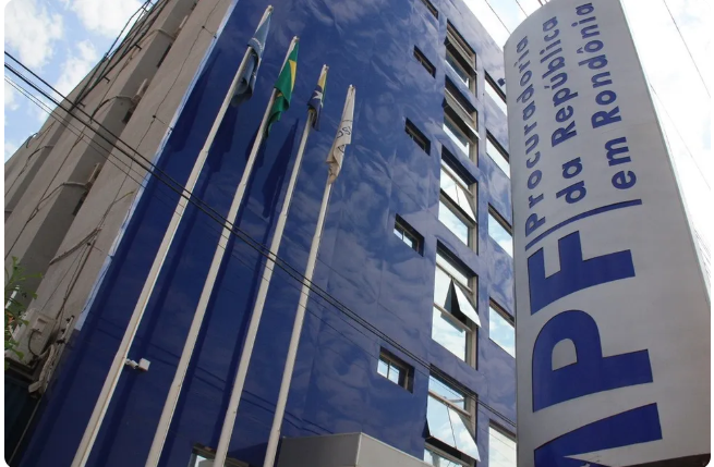 Fotografia mostra o prédio do MPF em Rondônia, com o letreiro e bandeiras na frente.