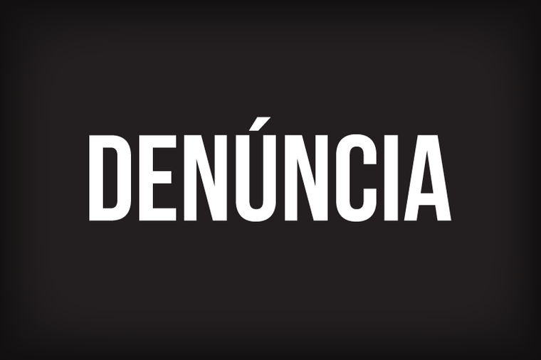 Palavra DENÚNCIA escrita sobre quadro na cor preta