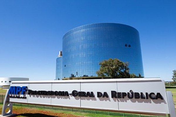 Ao fundo da imagem, o prédio arredondado e envidraçado da sede da Procuradoria-Geral da República. Em primeiro plano, um totem com a logomarca do MPF.