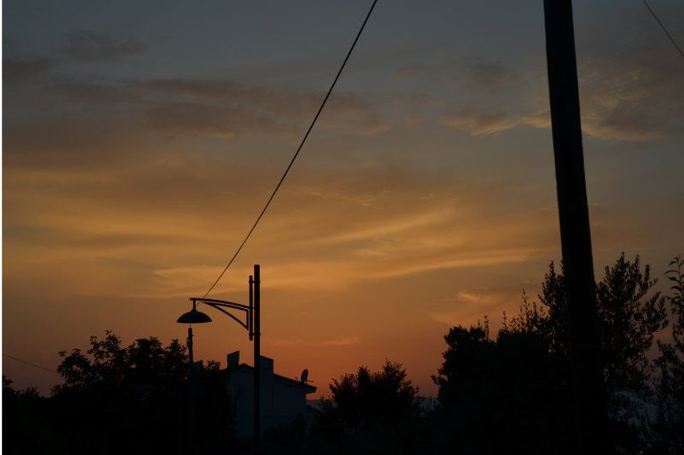 Foto de postes de luz em uma região rural em uma cena de pôr do sol