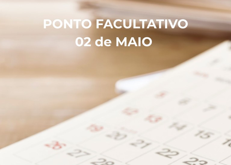 Foto com fundo desfocado onde está escrito ponto facultativo 02 de maio.