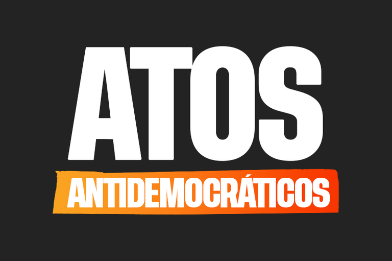 Imagem de fundo preto com a expressão atos antidemocráticos escrito ao centro com letras brancas e fundo laranja na palavra antidemocráticos