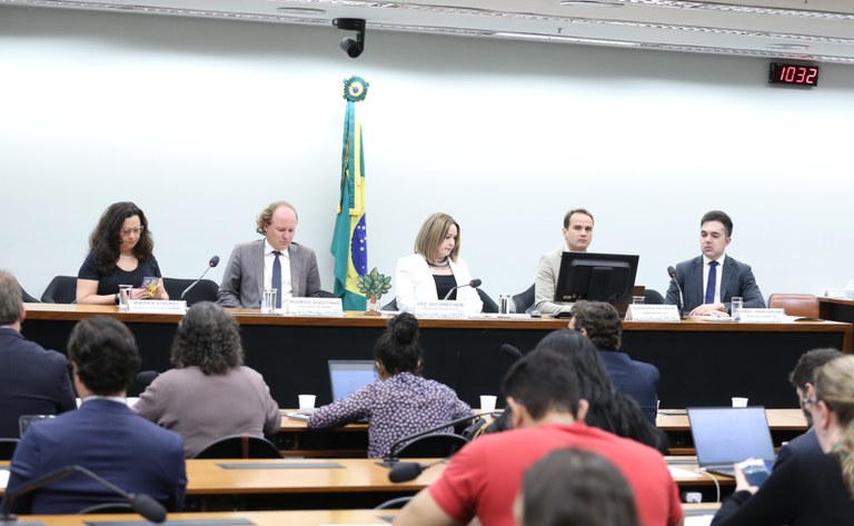 mesa de audiencia pública com cinco pessoas