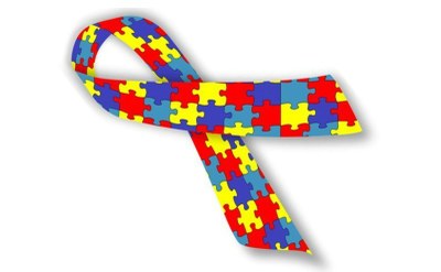 #pracegover: símbolo mundial de conscientização do autismo, representado por um laço formado por várias peças de quebra-cabeça coloridas