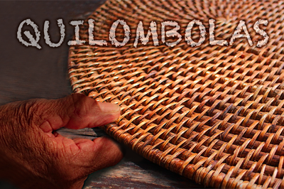 #pracegover A palavra quilombolas sobre a imagem de uma mão negra, segurando uma peça de artesanato circular, feita de palha.